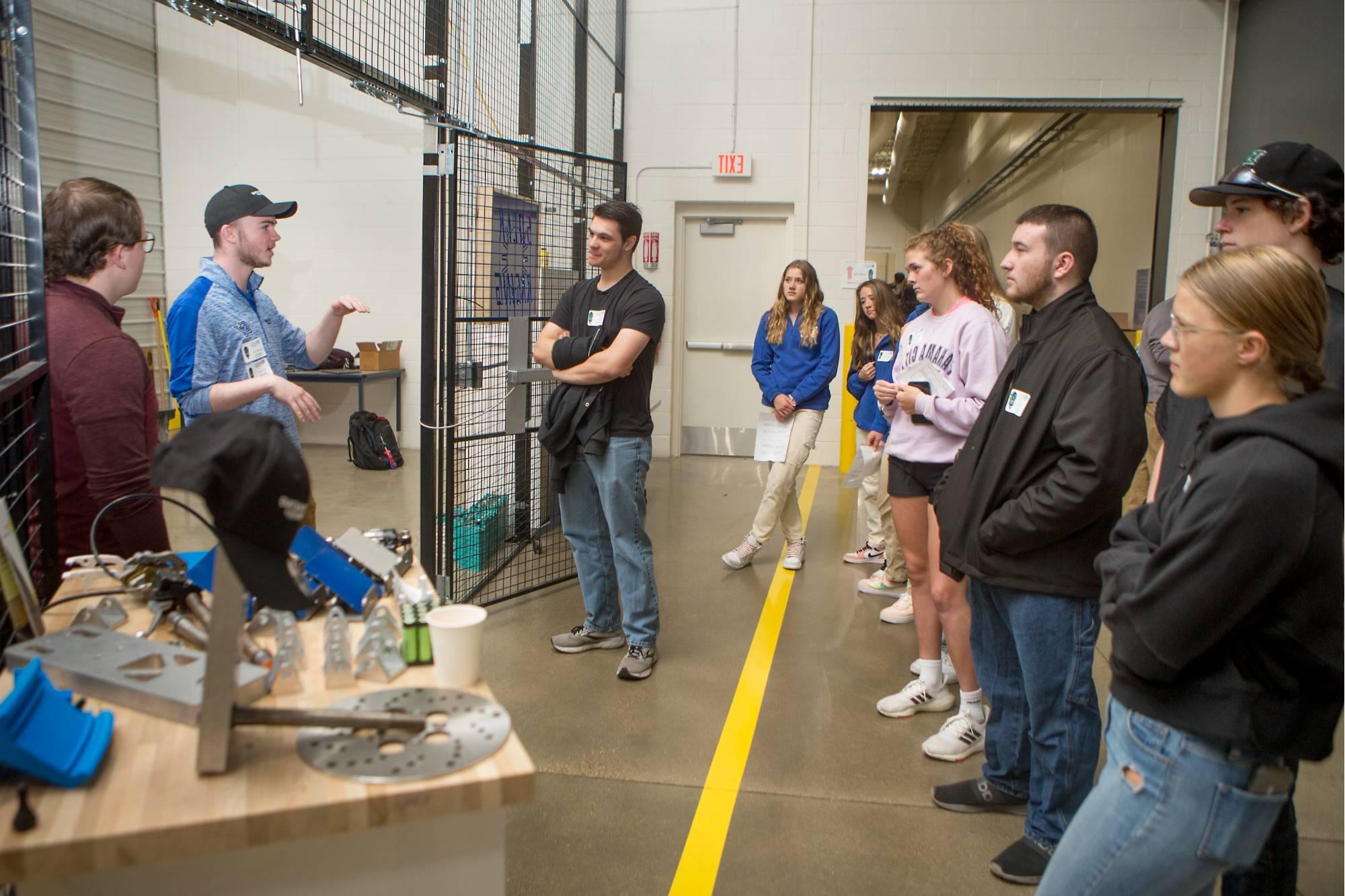 Students interacting at Project Day near Laker Racing solar car